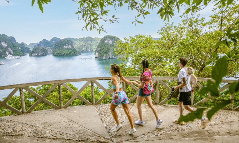 Three people running to the peak of Ti Top Island.