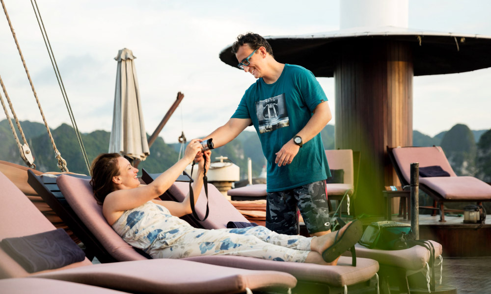 a couple lounging on the deck of mila cruise