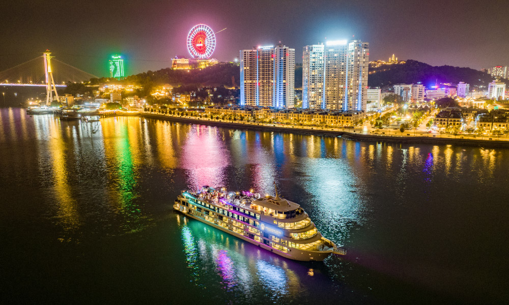 The Ambassador 2 Cruise at night sailing past the colorful halong City.