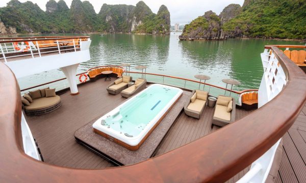 View from above down to a deck with a jacuzzi, facing Halong Bay islands.