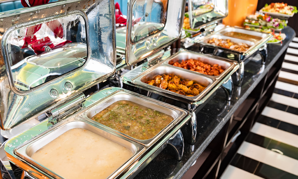 A buffet line with Vietnamese dishes.