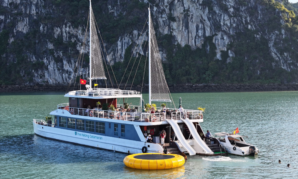 Close up of the Catba Catamaran ship with a trampoline on the side and water slides.