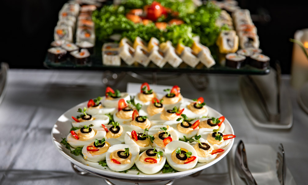 a plate of deviled eggs and sushi