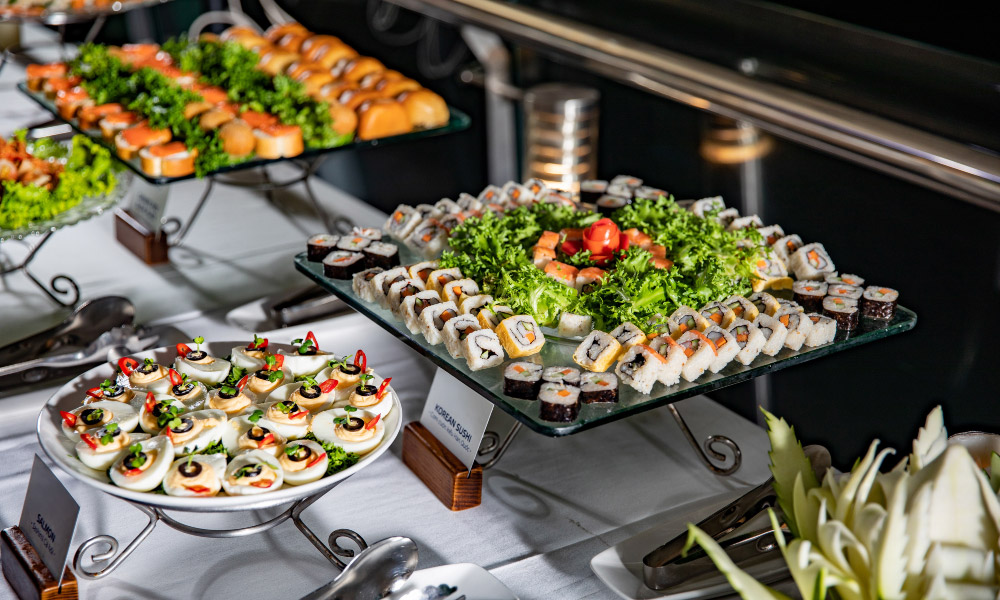 trays and bowls of buffet food