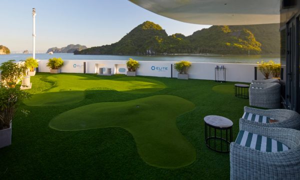 a golf court on the deck of elite cruise with open view of halong bay islands