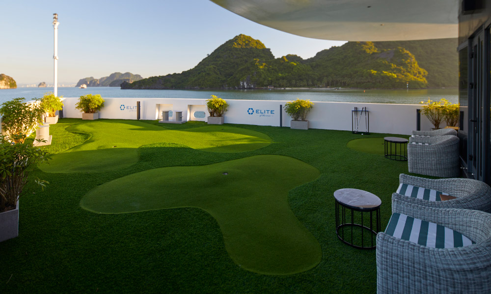 a golf court on the deck of elite cruise with open view of halong bay islands