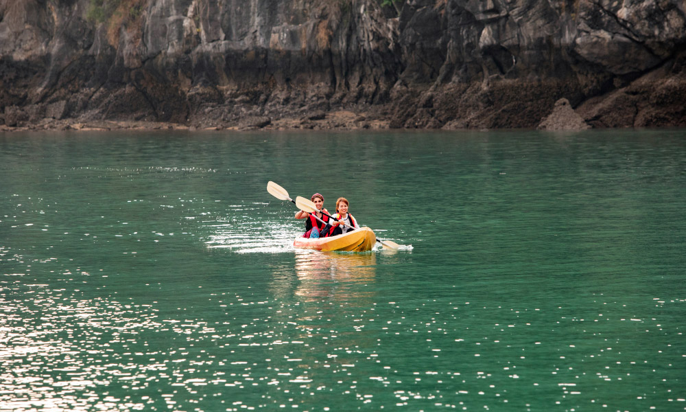 a couple on a kayak in the turquoise water