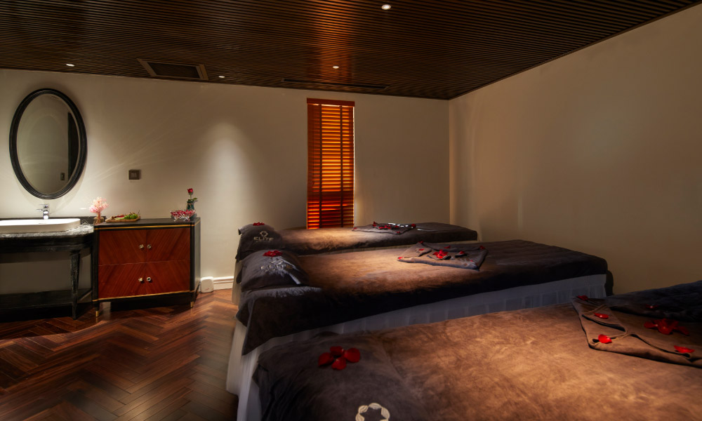 elite spa room with three beds and warm decoration