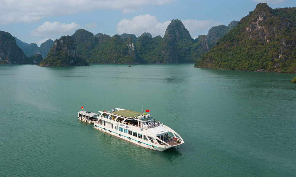 The Emeraude Sayuri Cruise sailing past Halong Bay islands.