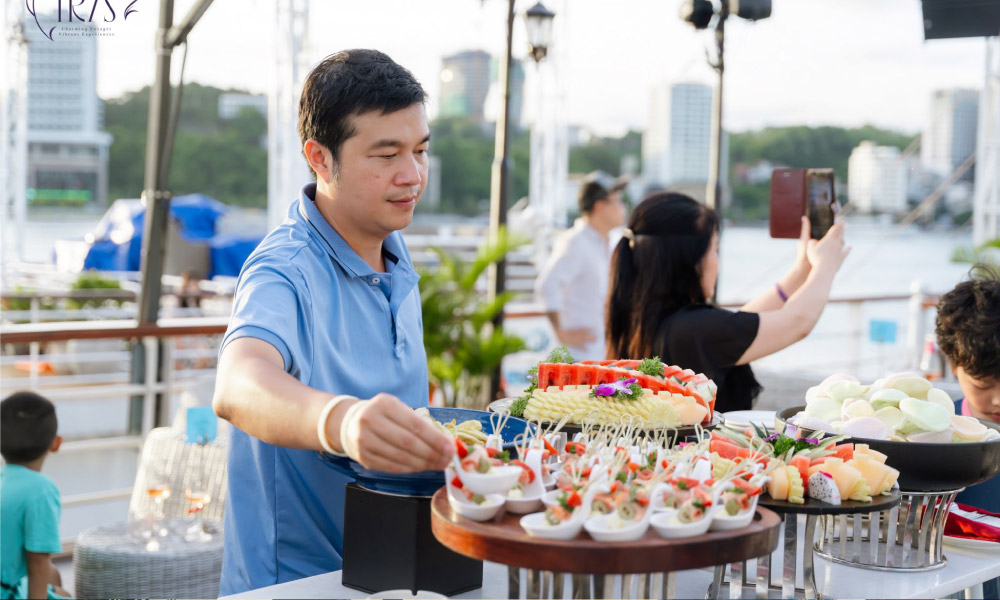 A man and other guests enjoying food for canape party.