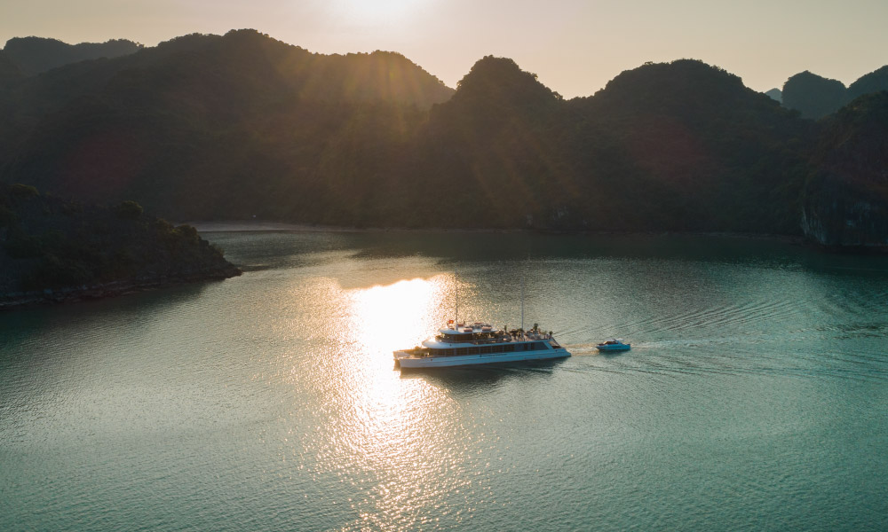 Panoramic view of Halong Bay islands during sunset surrounding Halong Catamaran Cruise.