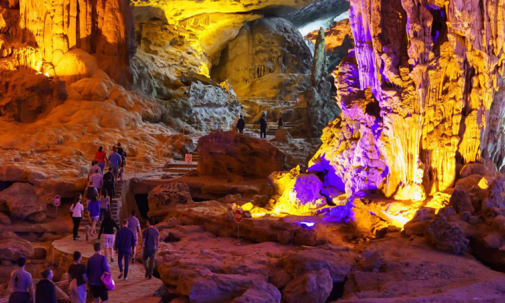 Magical view of stalactites in Sung Sot Cave with yellow and pink lights.