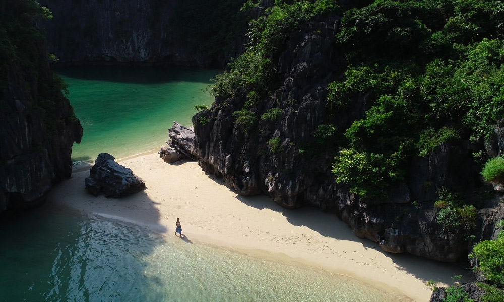 An island and small beach looking from afar.