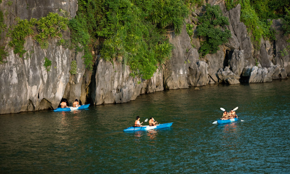 three kayaks in the middle of halong bay