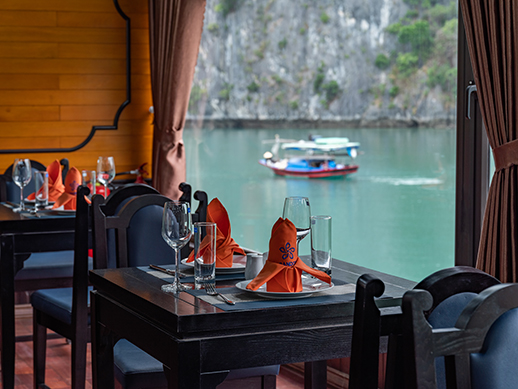 table setup in the restaurant of la pandora boutique with a sea-view window