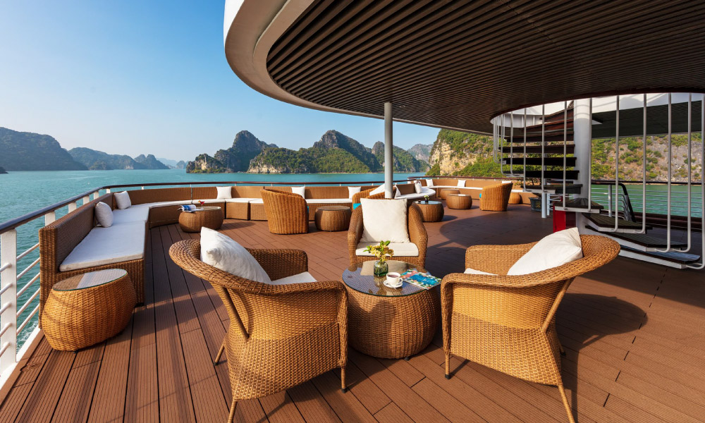 The lounge area on the deck of Capella Cruise with brown chairs.