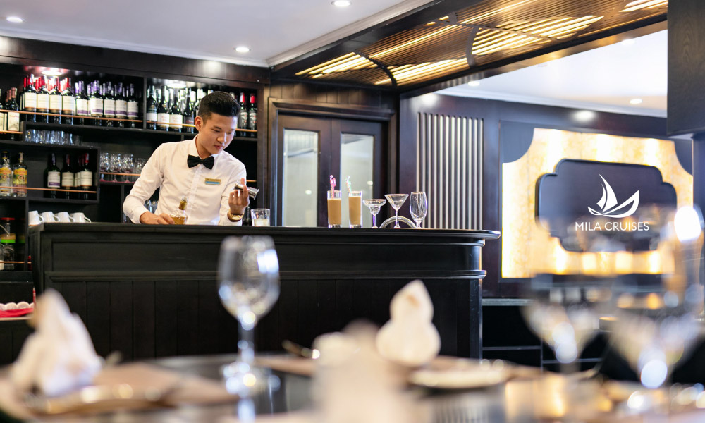 a bartender making drinks and the view from the table in front of him