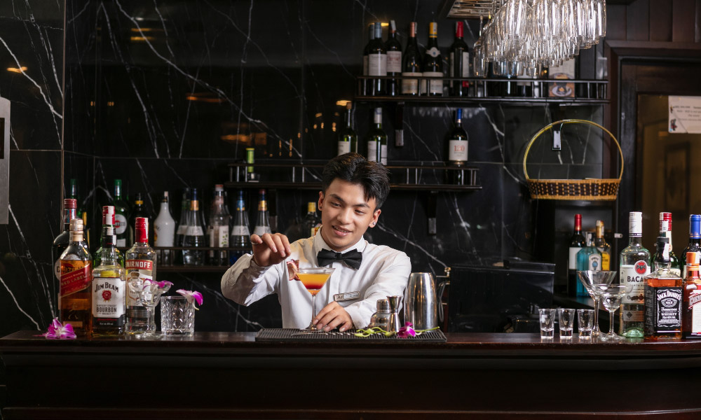 a bartender making drinks on mila lux cruise