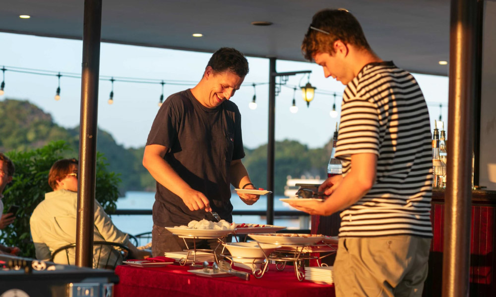 two men taking food and drinks