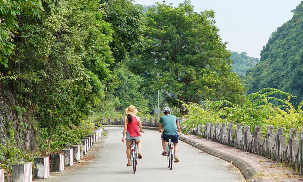 two people cycle in viet hai village