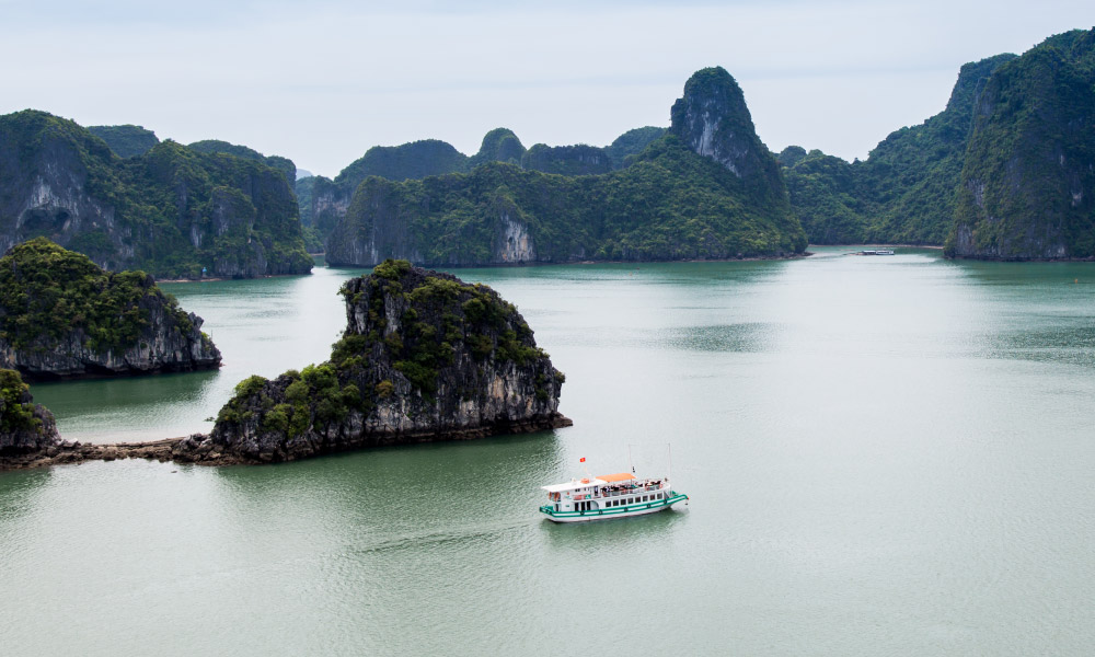 Fly cam view of the Emeraude Min Cruise sailing in the middle of Halong Bay.