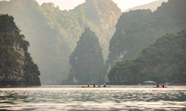 scenery of halong bay with small kayaks among the islands