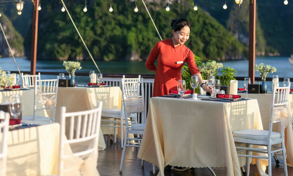 the staff of mila lux cruise setting the table on the deck