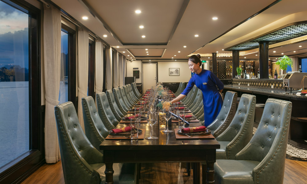 a row of tables in the restaurant of hermes cruise