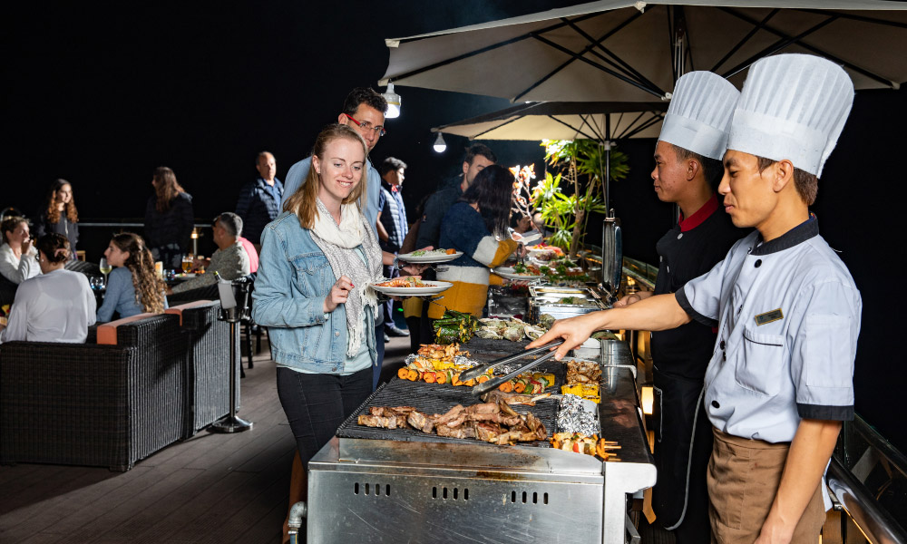 side view of the bbq station with chefs handing out food