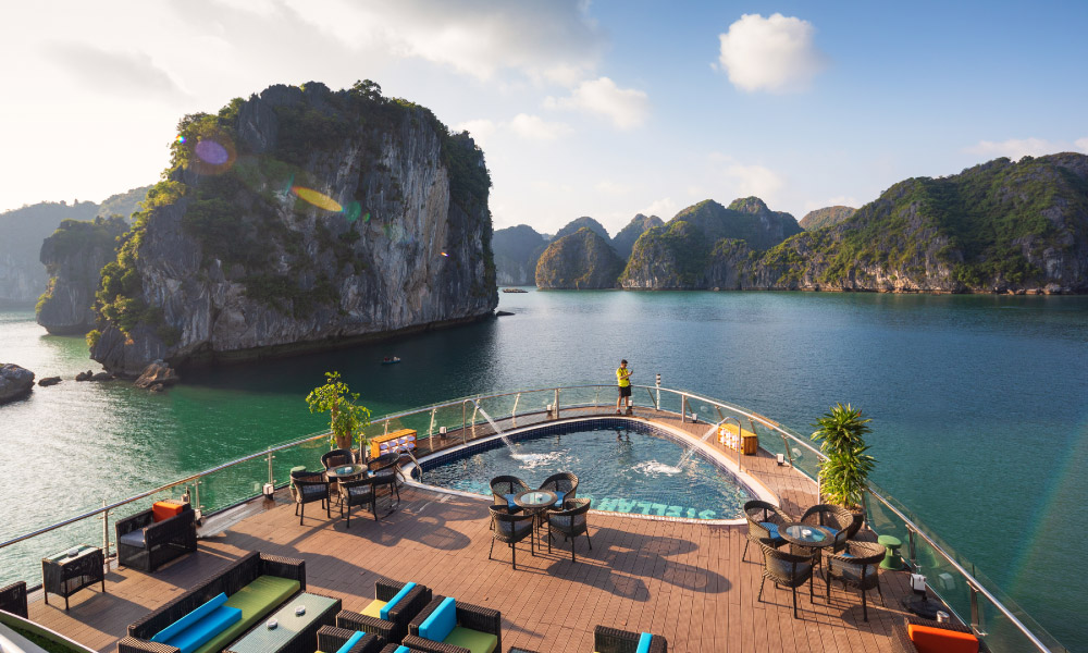 the sundeck and pool on stellar of the sea cruise, with open view of halong bay sea and islands