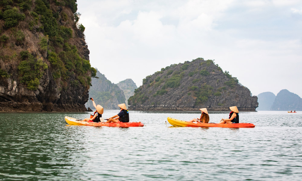 two orange kayaks in the middle of halong bay