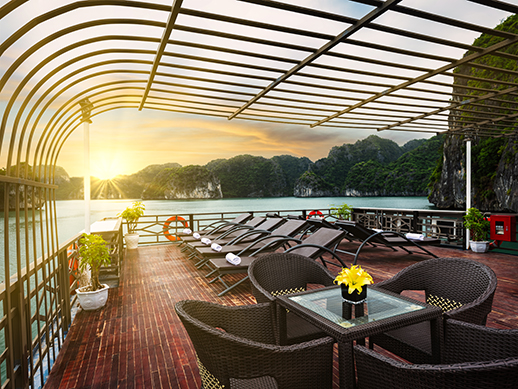 the sunset over halong islands from the deck of pandora boutique