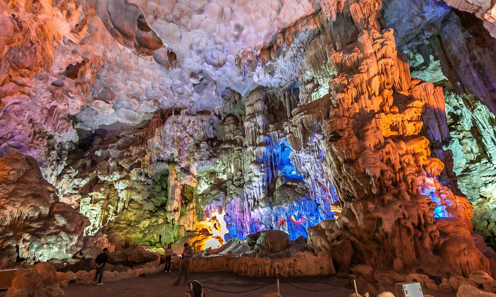 Sung Sot Cave under colorful light.