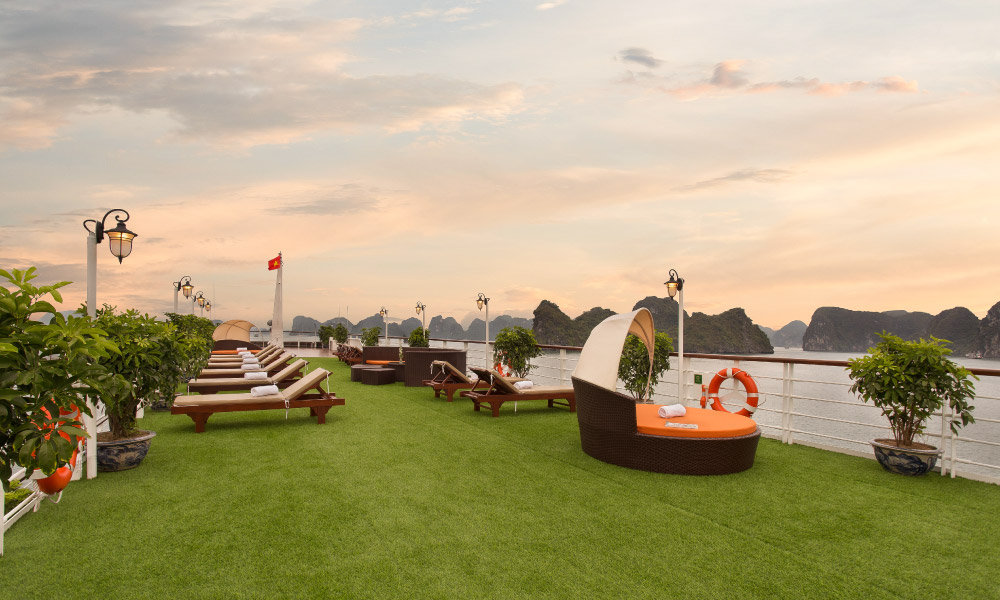 the mon cheri sundeck with lounge chairs during sunset hour