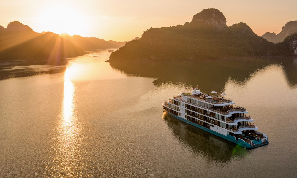 The Capella Cruise going in Halong during sunset hour.