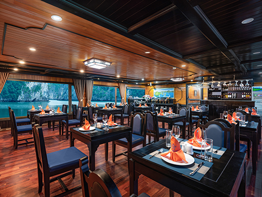 the left side of the restaurant on la pandora boutique cruise with wooden tables and chairs