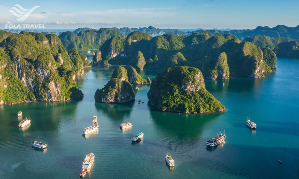 Panoramic view of Halong Bay islands on the right, sea, and cruises.