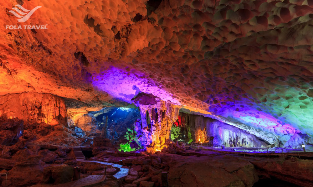 Sung Sot Cave in Halong with big stalactites system under colorful lights.