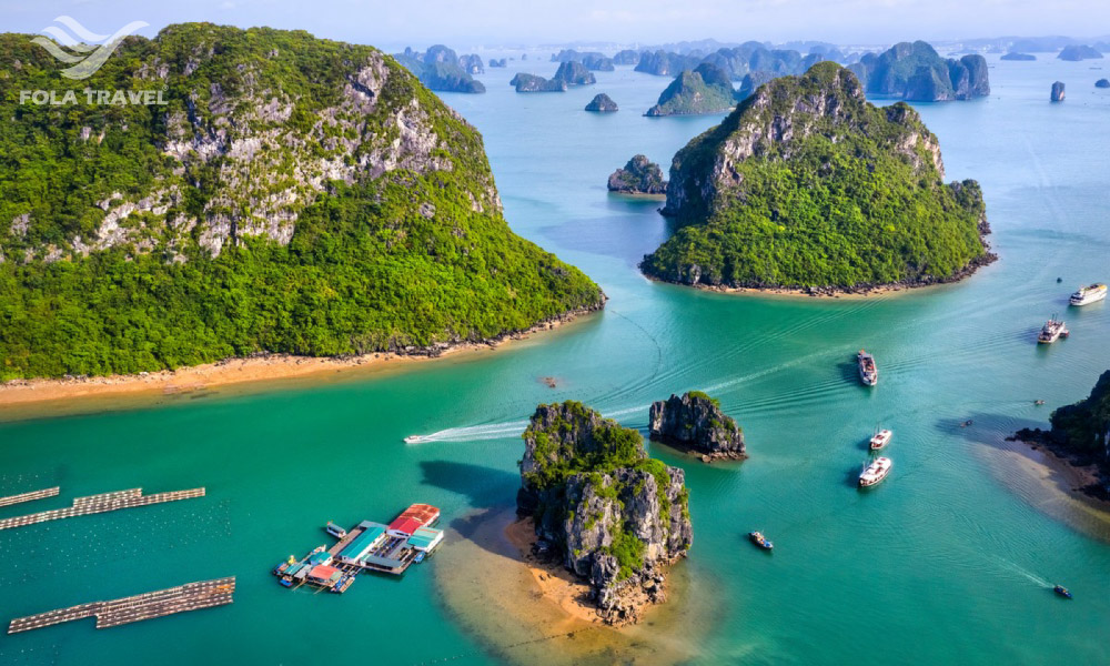 Panorama of Vung Vieng fishing village in the middle of a bay with islands and boats.