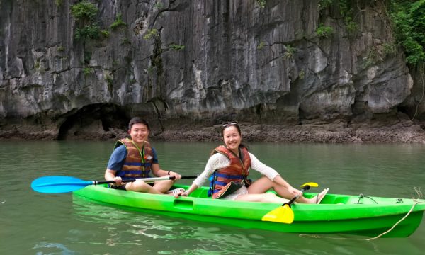 Guests of Hercules Premium Cruise sitting on a green kayak.