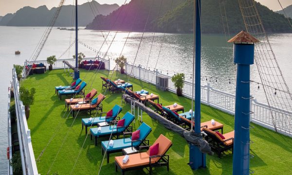 The sundeck of Verdure Luxury cruise looking from above with two rows of colorful sun chairs.