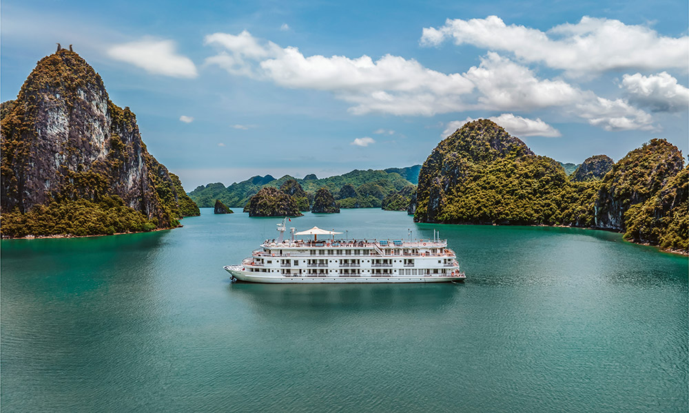 Ambassador Signature Cruise sailing in the middle of Halong Bay islands.