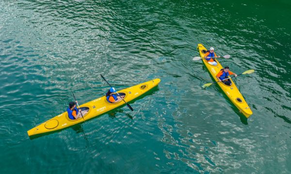 two yellow kayaks in the turquoise water look from above