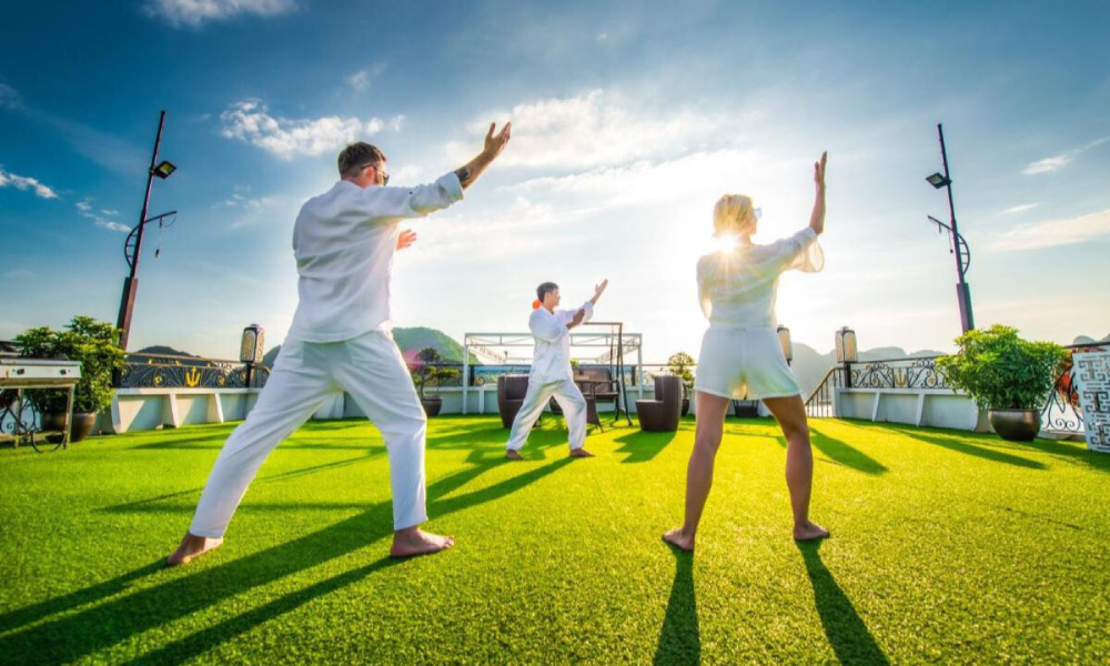 Three people doing Tai Chi Class on the sundeck