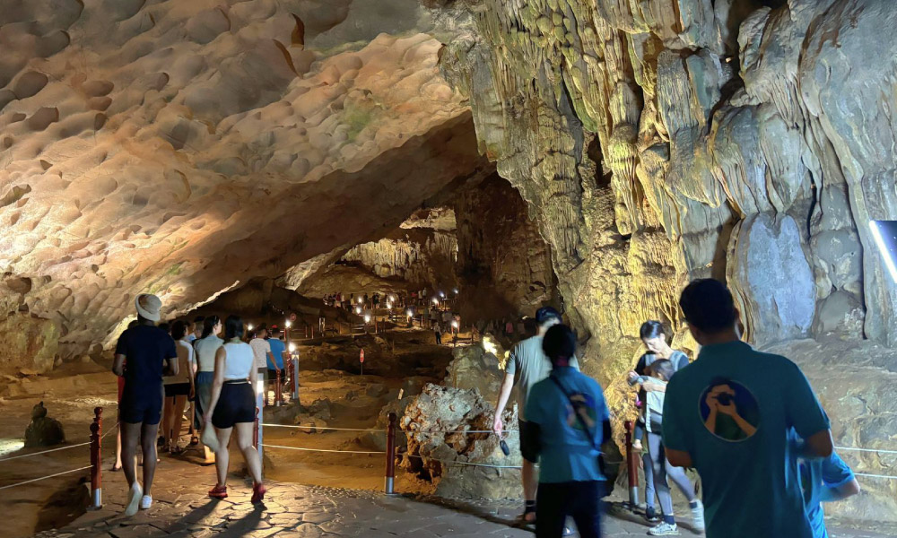 Inside a Halong Bay cave with many people visiting.