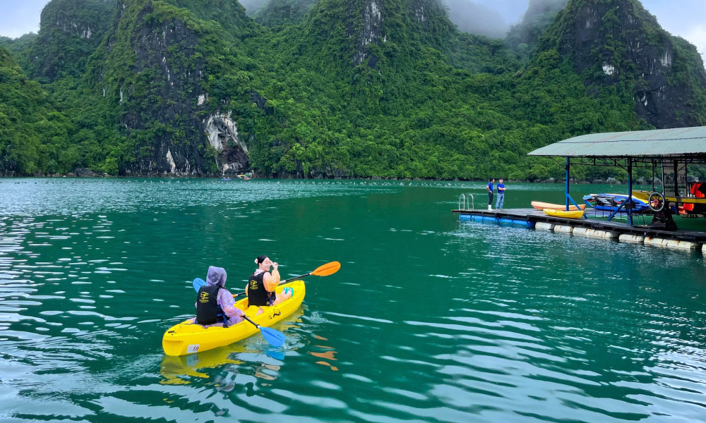 Guests kayaking in the middle of Halong Bay.