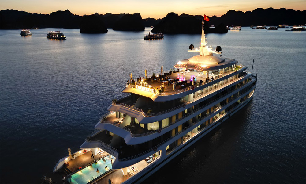 The Catherine Cruise at night with Halong Bay islands afar.