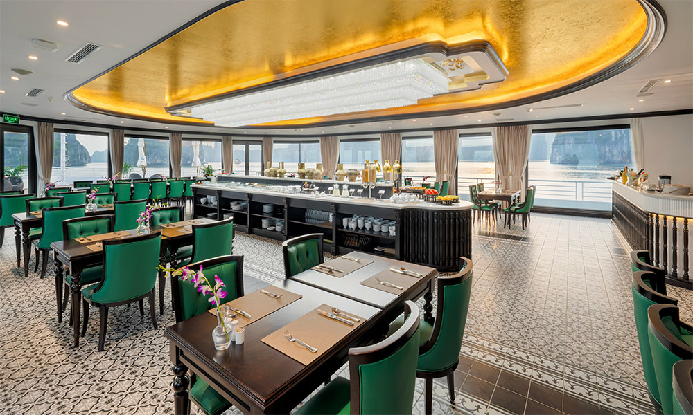 Side view of a restaurant with sea-view windows and yellow ceiling.