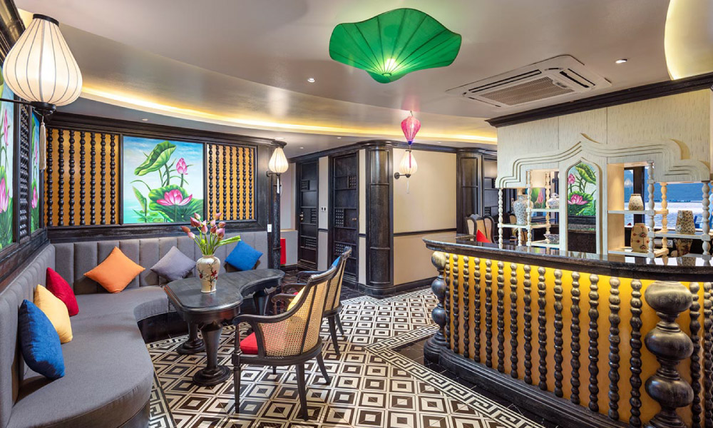 A corner in a luxury restaurant on Verdure Cruise with a bar on the right and sofa on the left.