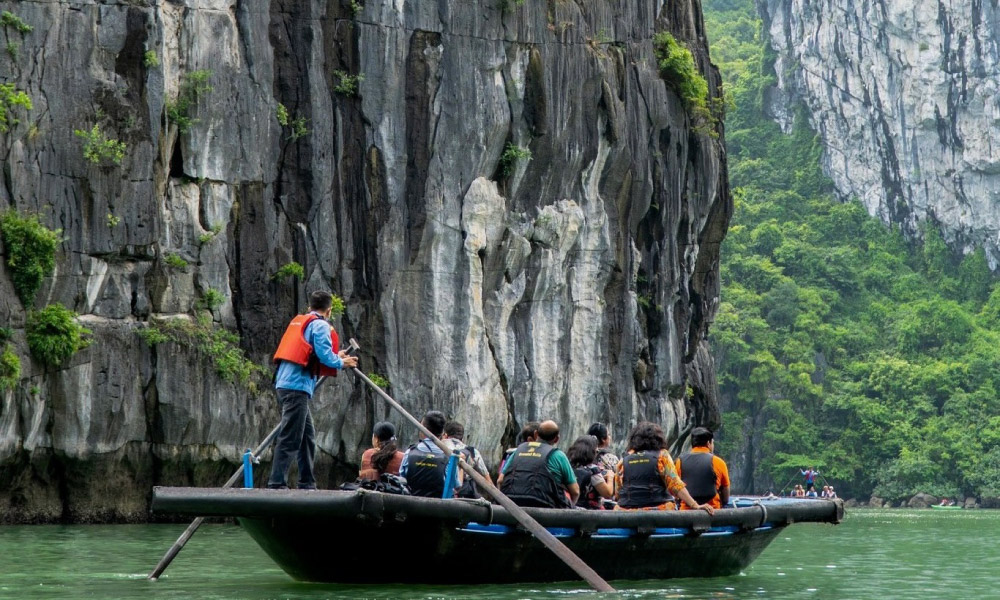 Guests discovering Halong Bay on a bamboo boat